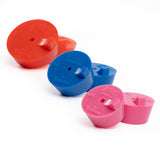 An assortment of silicone purge plugs in red 2", blue 1.5", and pink 1.25" schedule nominal pipe for high purity turbo manifold fabrication