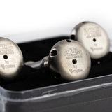 TIG Aesthetics shower head diffuser upgrade packaging on a white background with three pieces of raw titanium shower head diffusers with precision CNC machined outlet ports, displayed against a white background with TIG Aesthetics and Ticon logo laser etched on the bottom.
