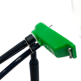 One TIG Aesthetics silicone flat trailing shield for TIG welding, in green, with a metal diffuser and a hose retention tab installed on welding torch