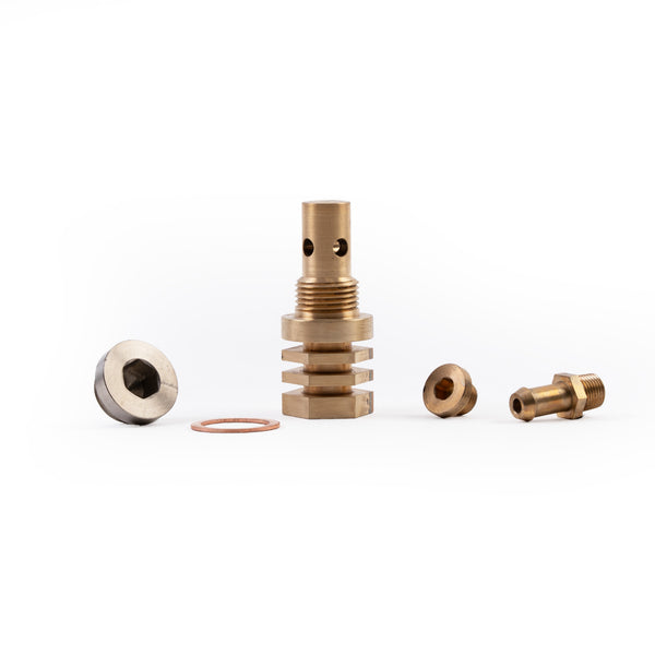 A Copper bronze colored copper chill block designed for use in welding with an M18 O2 bung on white background not installed with fittings from lower angle