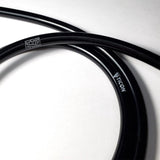 A zoomed in photo showing detail coiled black silicone argon purge line with white tig aesthetics and ticon branding on it