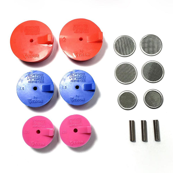 An assortment of silicone purge plugs in red 2.", blue 1.5", and pink 1.25" schedule nominal pipe with stainless steel mesh diffusers and titanium argon inlet tubes. for high purity turbo manifold fabrication